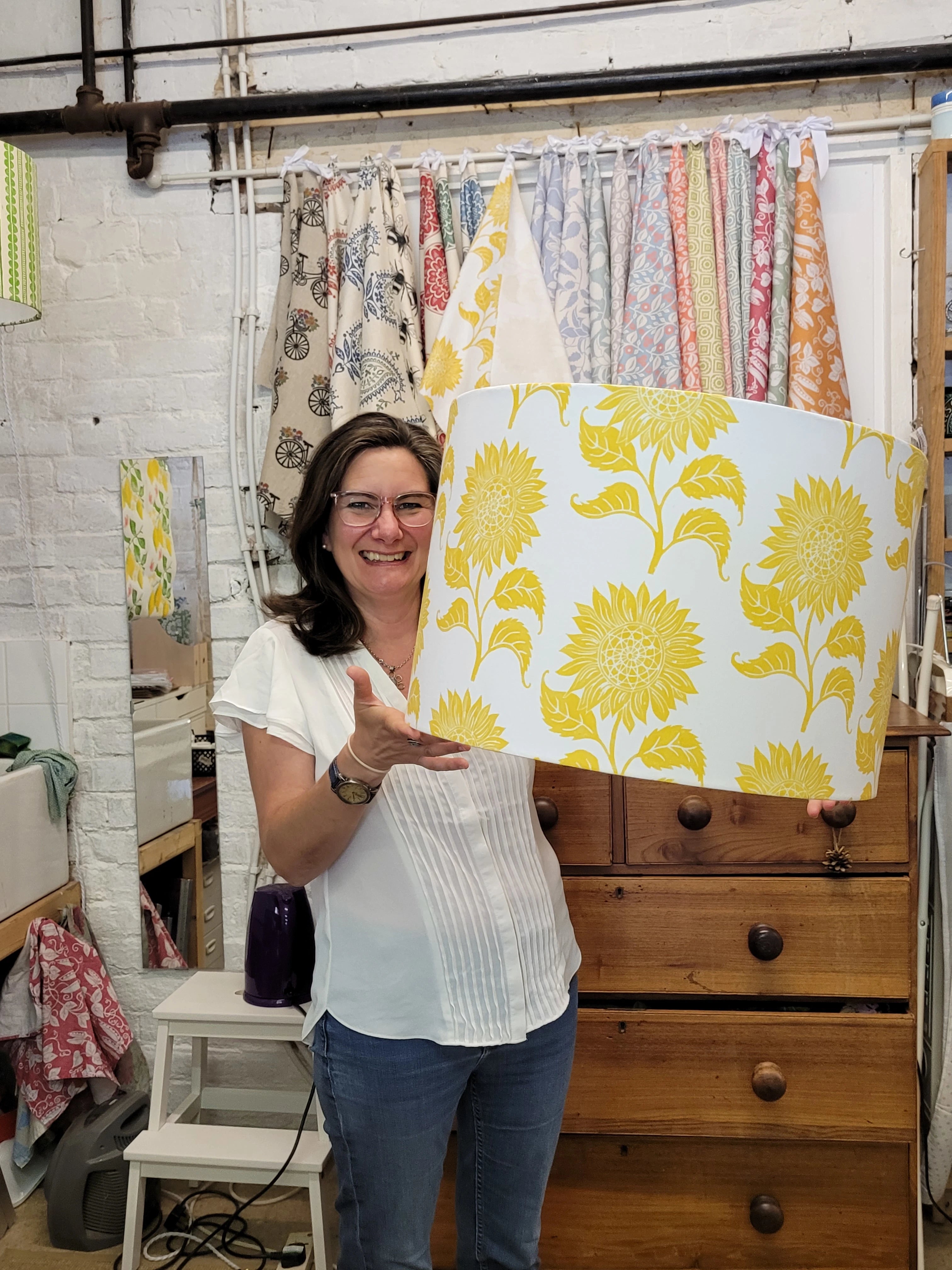 lizzie mabley holding large sunflower design lino block printed lamshade 