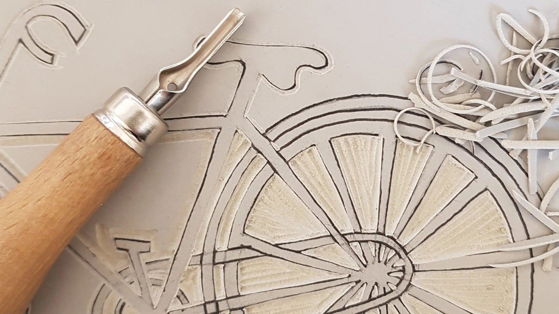carving lino block for printing vintage bicycle designed by lizzie mabley