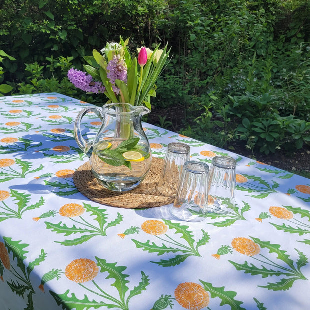 dandelion tablecloth designed by lizzie mabley on an outdoor table in the garden