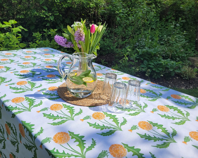 dandelion tablecloth designed by lizzie mabley on an outdoor table in the garden