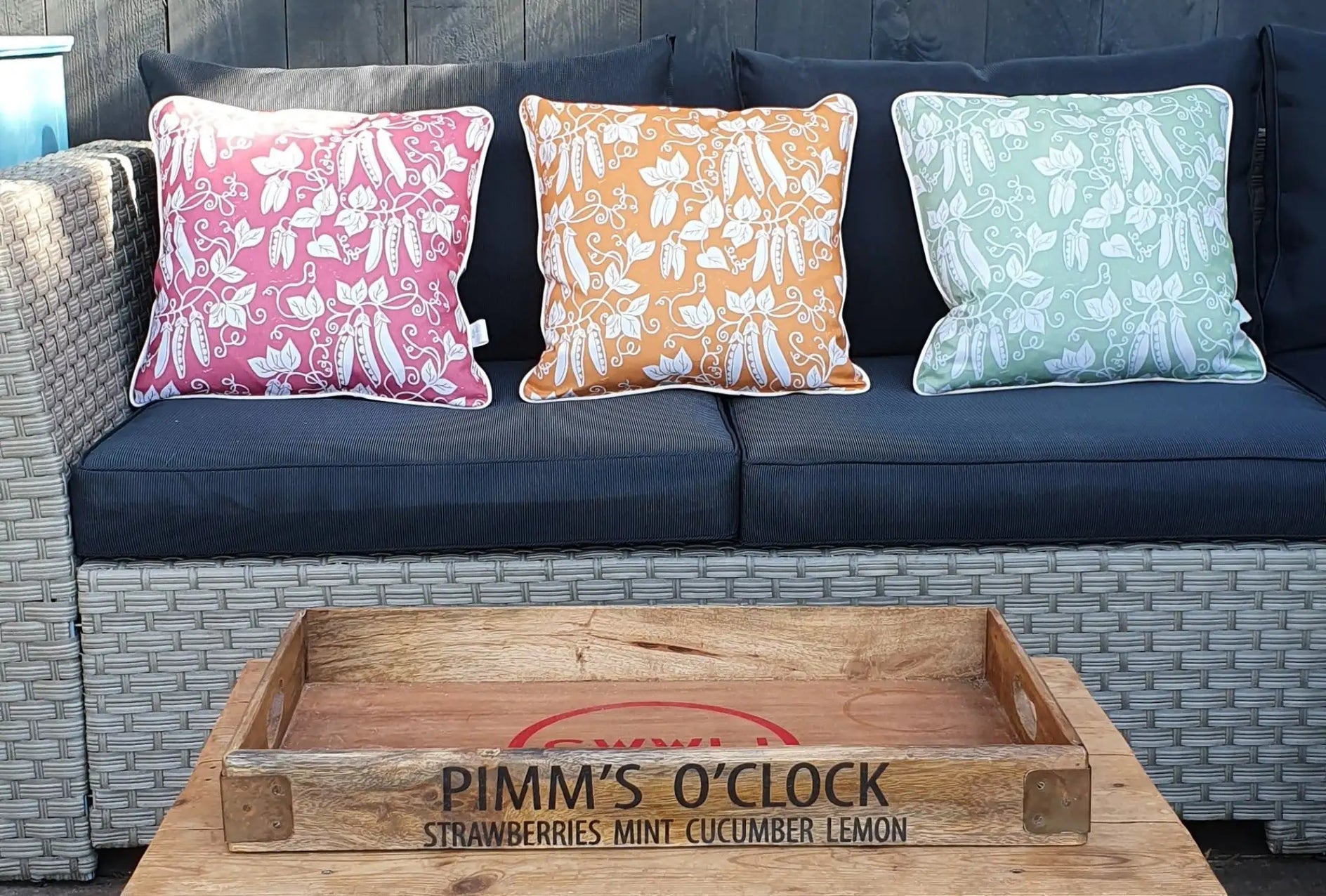 peas cushions designed by lizzie mabley on an outdoor sofa in an outdoor room