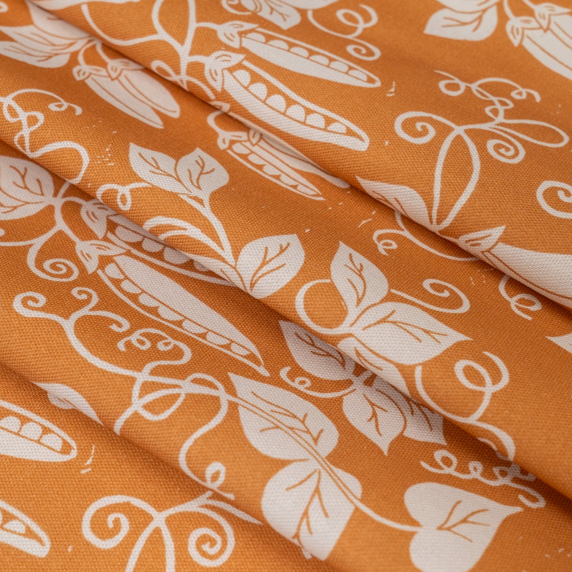 Pumpkin Orange Peas lino block printed fabric designed by Lizzie Mabley