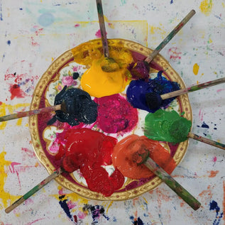 decorative bowl containing multi coloured inks for Lizzie mabley teaching a lino block printing workshop in her studio 