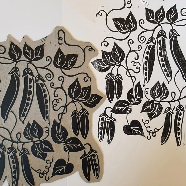 inking lino blocks for printing peas design by lizzie mabley