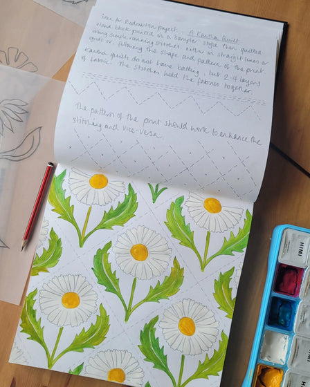 Lizzie mabley designing fabrics in her sketch book